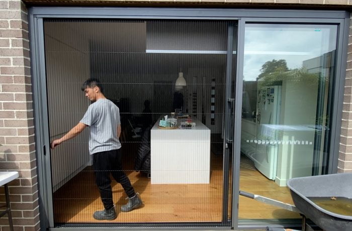 Man holding a rectractable flyscreens