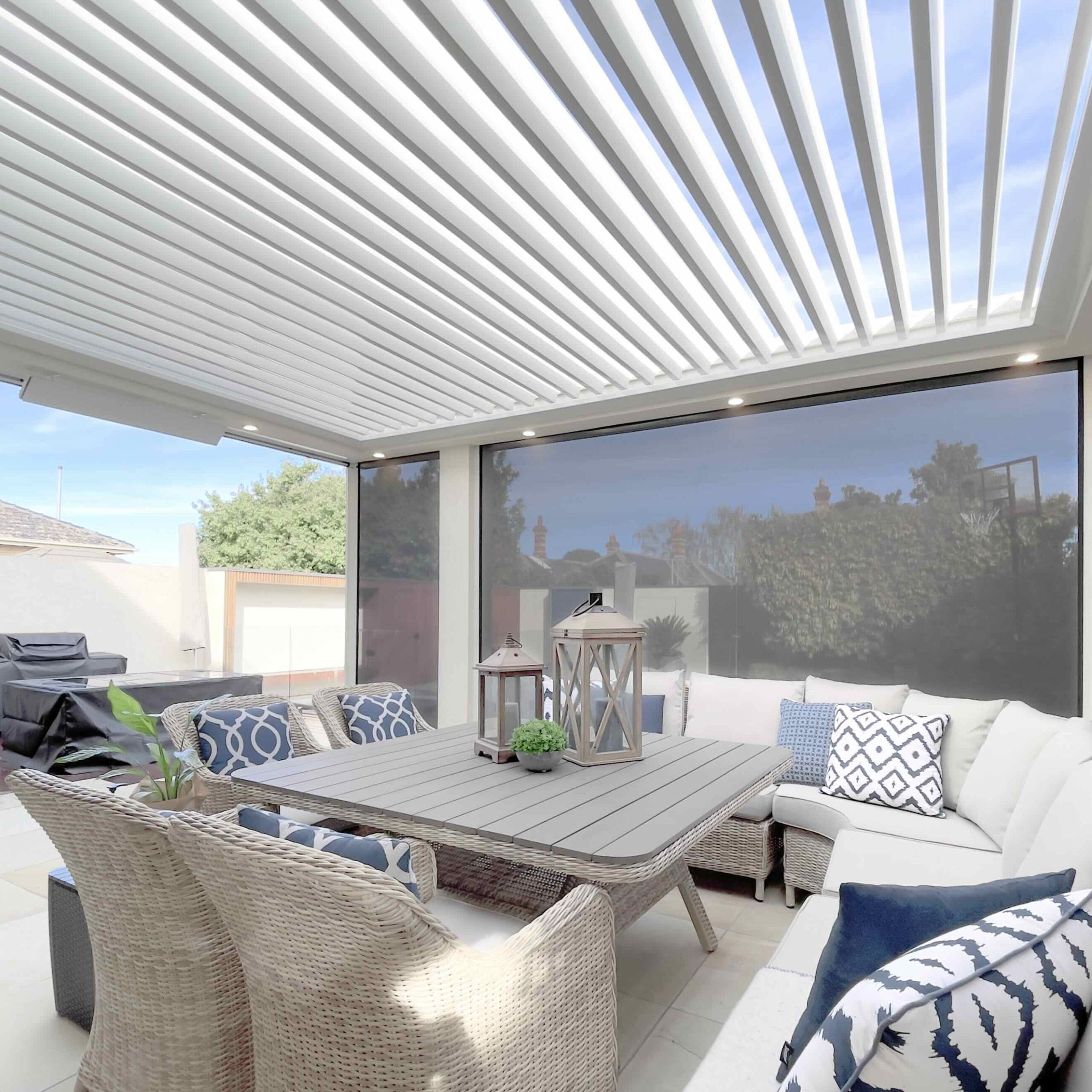 Outdoor blinds in a afresco area with a louvre roof